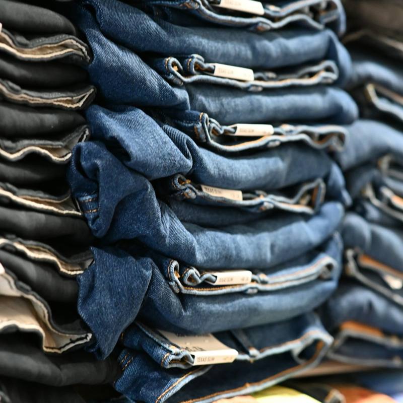 Stacks of folded blue denim jeans