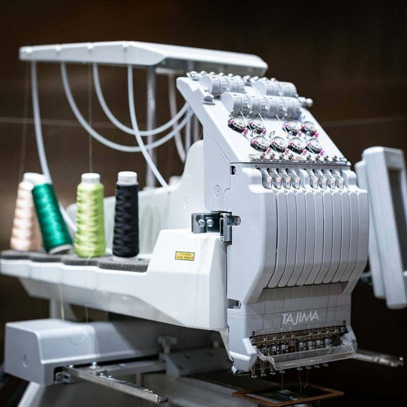 Multi-head embroidery machine loaded with thread cones