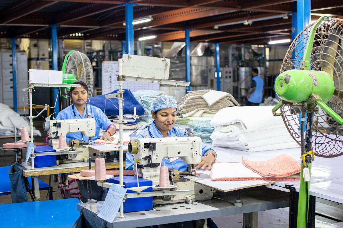 Garment workers at a row of industrial sewing machines