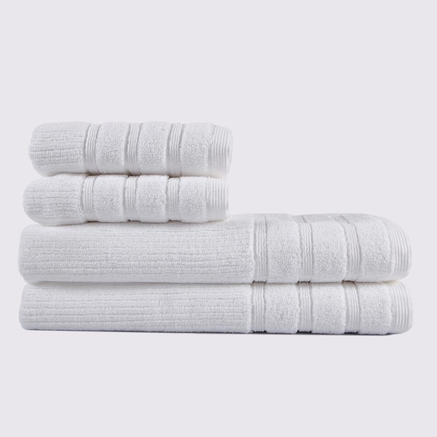 Stack of white hotel towels in four sizes with dobby borders